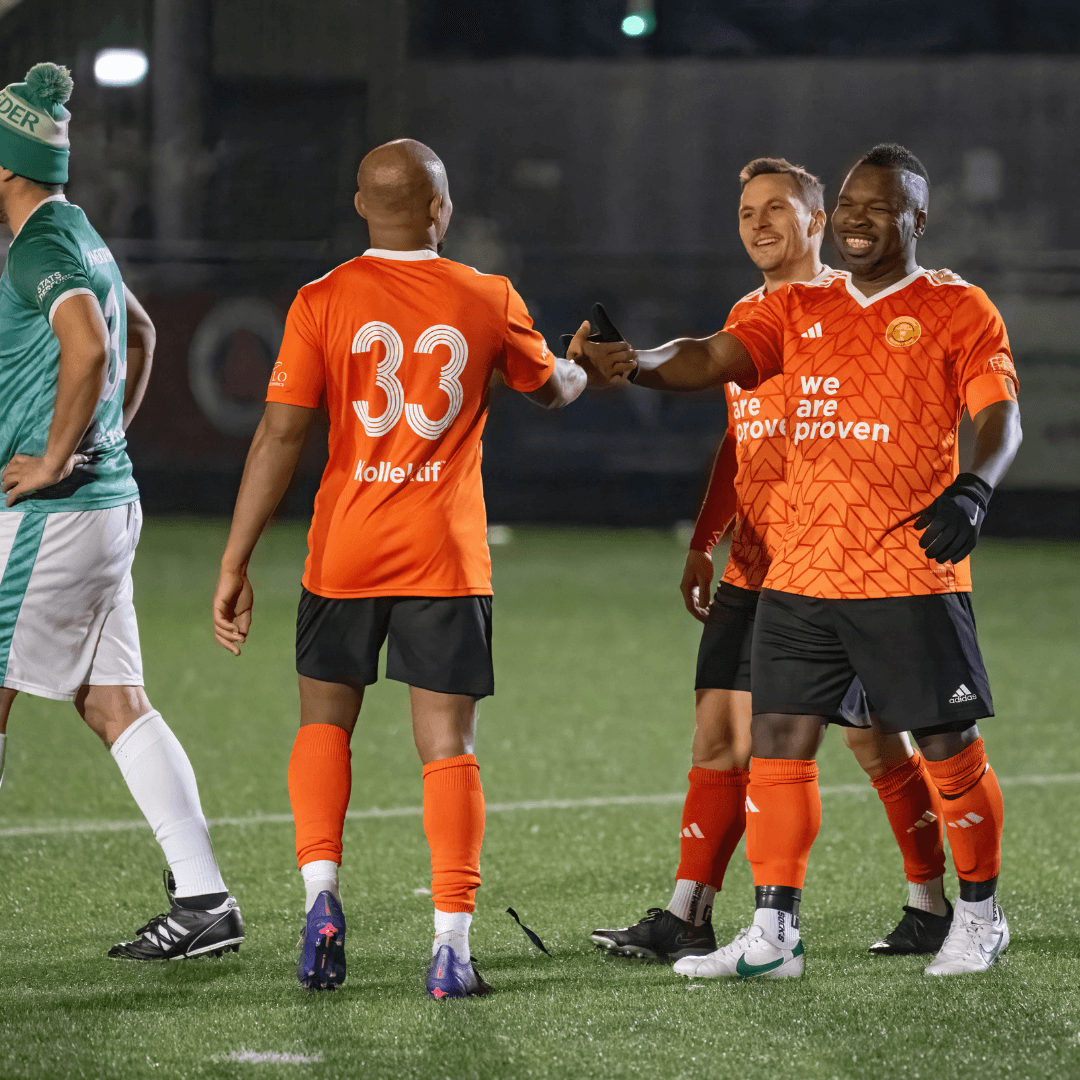 Football legends celebrating after a match, showcasing teamwork and camaraderie at Dorking Wanderers.